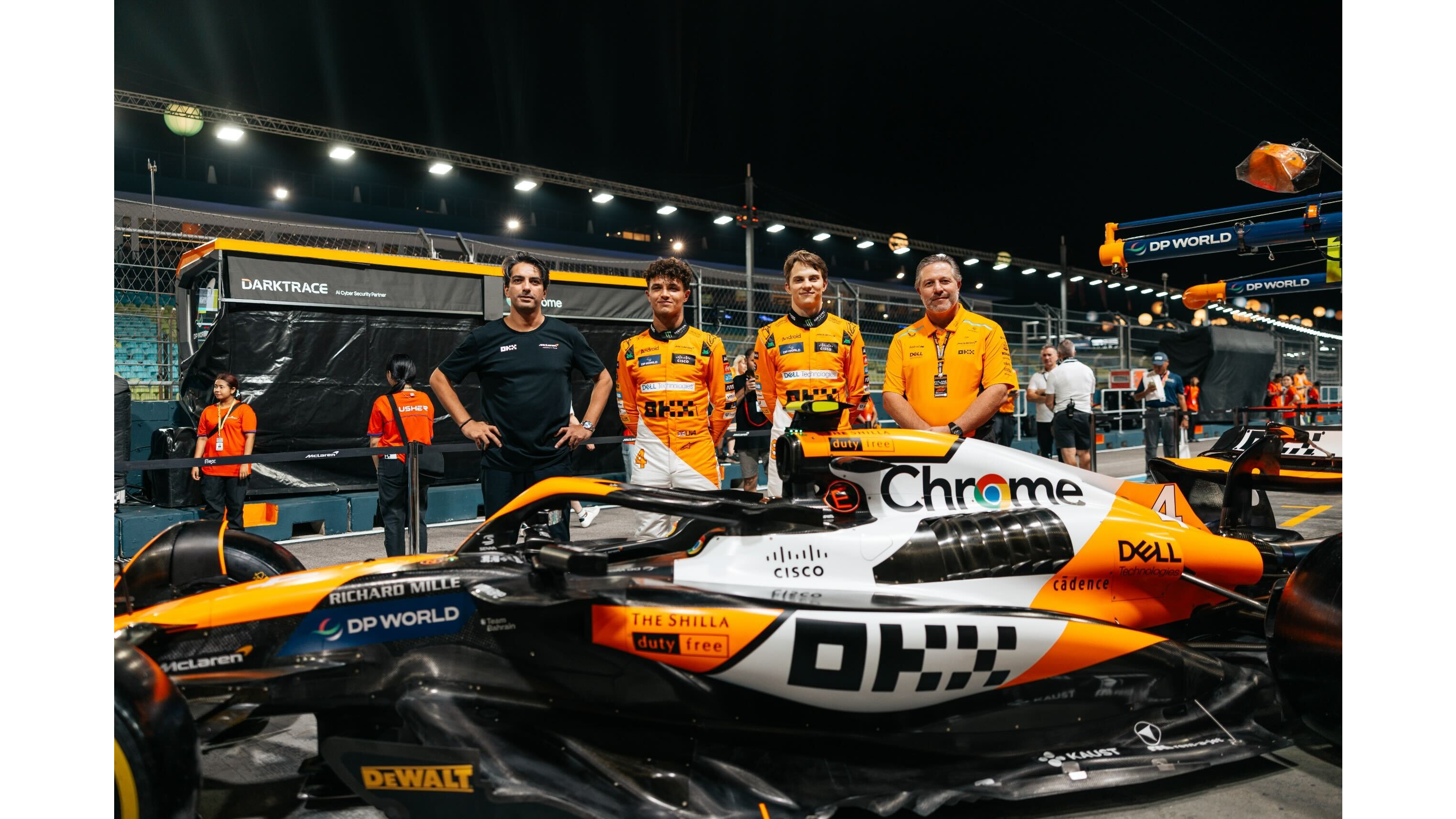 OKX CMO Haider Rafique with McLaren drivers Lando Norris and Oscar Piastri before the Singapore Grand Prix on September 1, 2024. (Courtesy: McLaren and OKX)