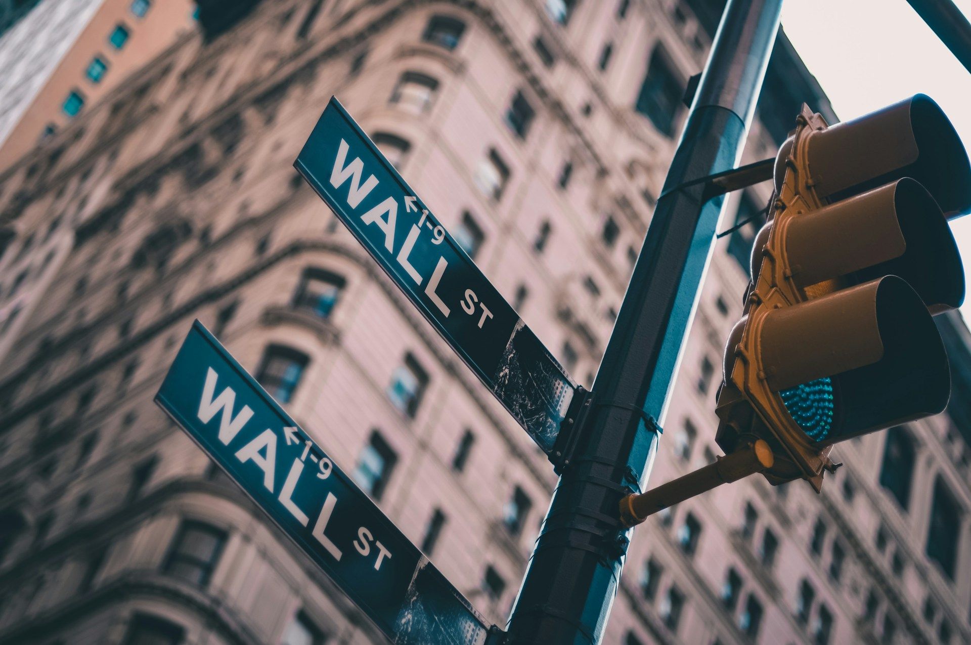 Wall Street signs (Lo Lo/Unsplash)