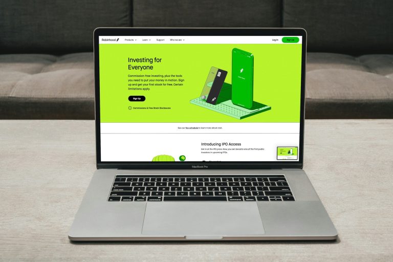 A Macbook Pro opened to Robinhood's website.