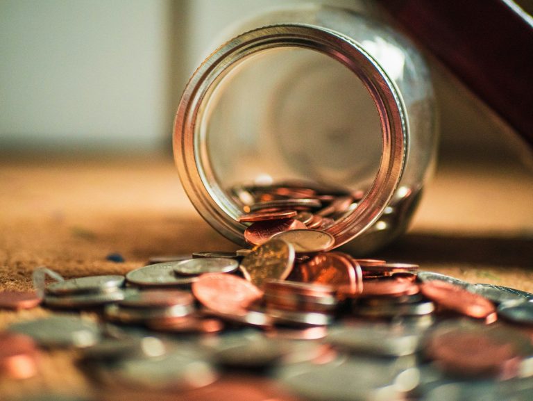 Coins falling from a jar. (Josh Appel/Unsplash)