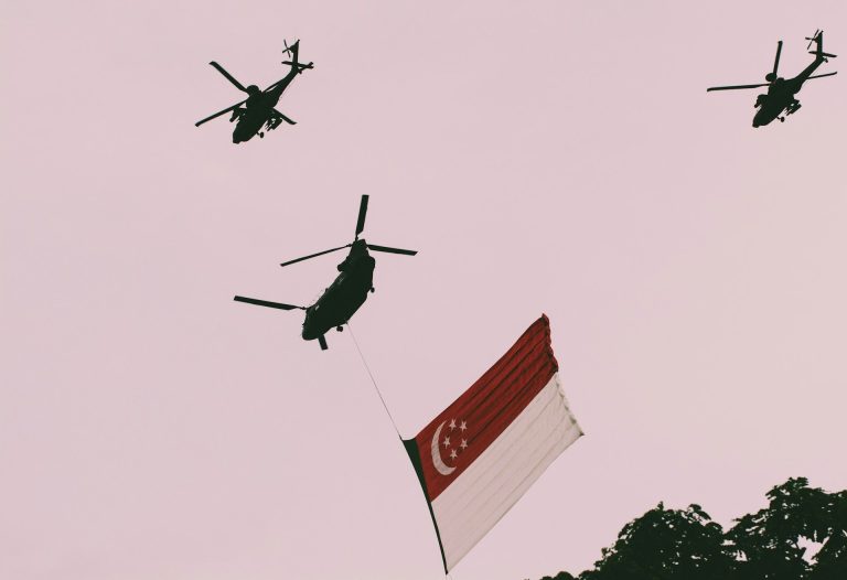 Singaporean flag under helicopters (Tomas Vyšniauskas/Unsplash)